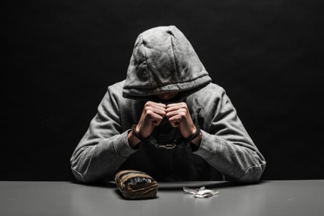 Man with drugs in handcuffs